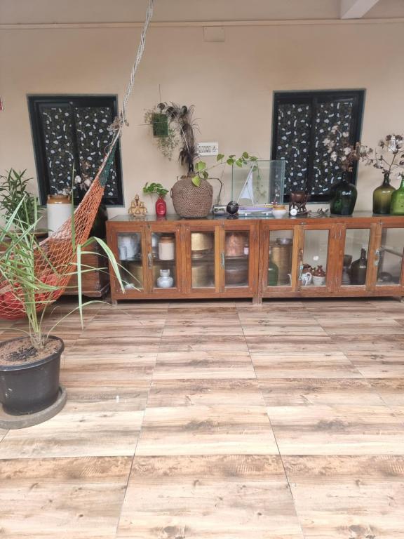 a room with a wooden cabinet with potted plants on it at Dream Vision Guest House in Diu