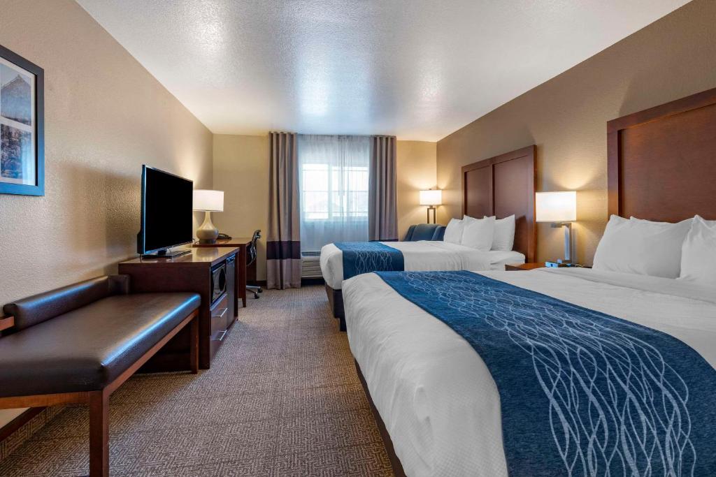 a hotel room with two beds and a flat screen tv at Comfort Inn & Suites Ukiah Mendocino County in Ukiah
