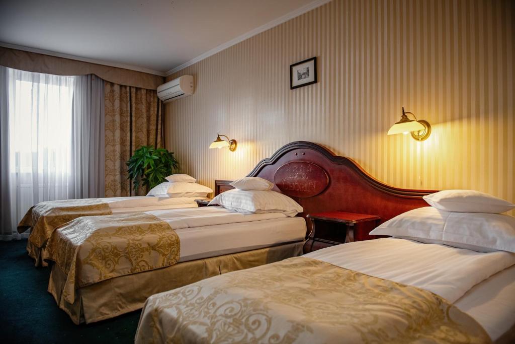 Postel nebo postele na pokoji v ubytování Hotel Chopin Business&SPA