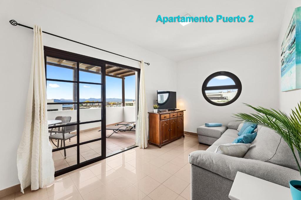 a living room with a couch and a television at Apartamentos Puerto 1, 2 y 3 in Playa Blanca