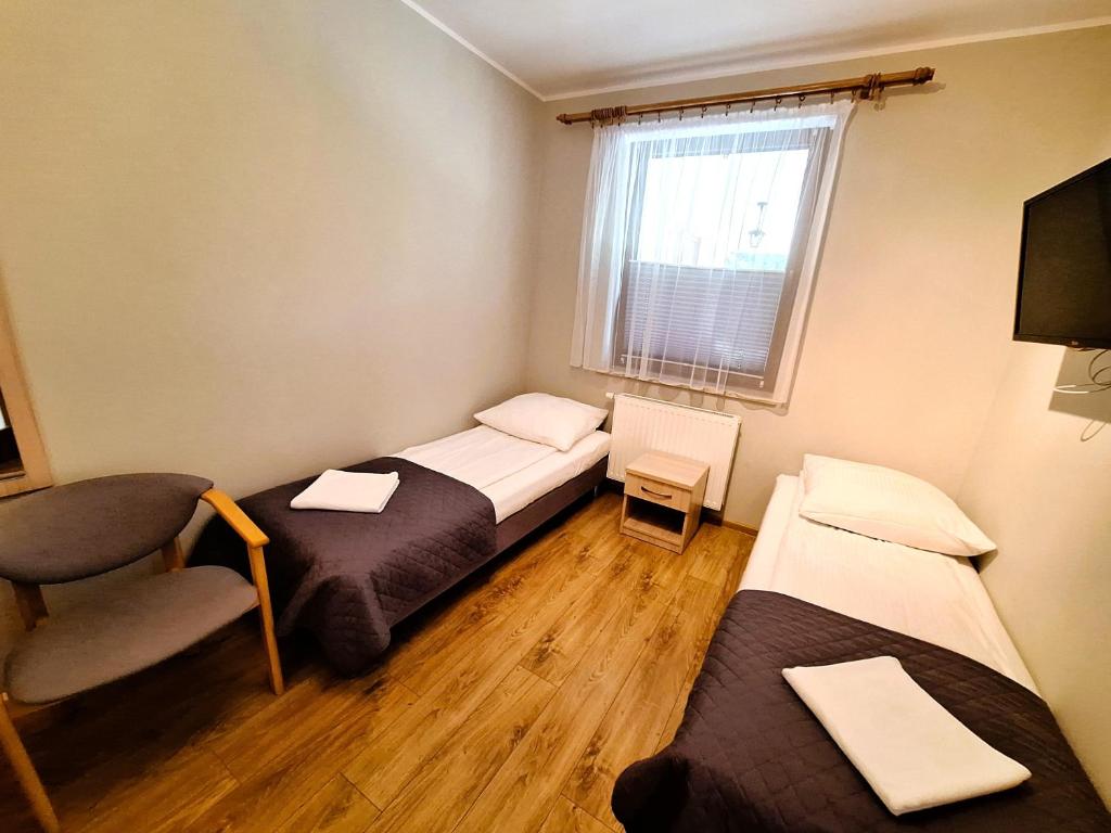 Posteľ alebo postele v izbe v ubytovaní Pokoje Gościnne Maczek