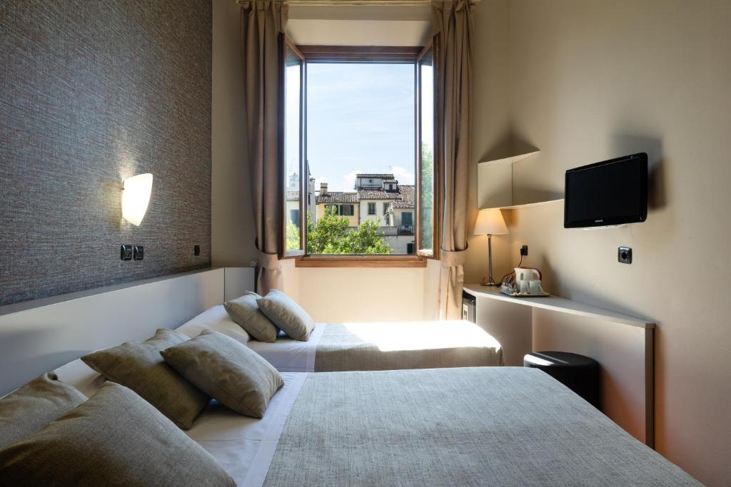 Łóżko lub łóżka w pokoju w obiekcie Hotel Caravaggio