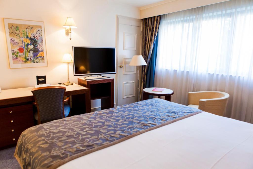 Postel nebo postele na pokoji v ubytování Hotel Le Châtelain