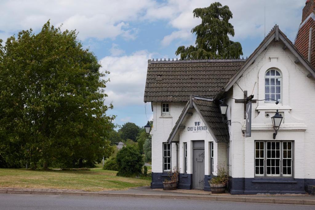 a white building on the side of a street at Crossroads by Chef & Brewer Collection in Weedon Bec