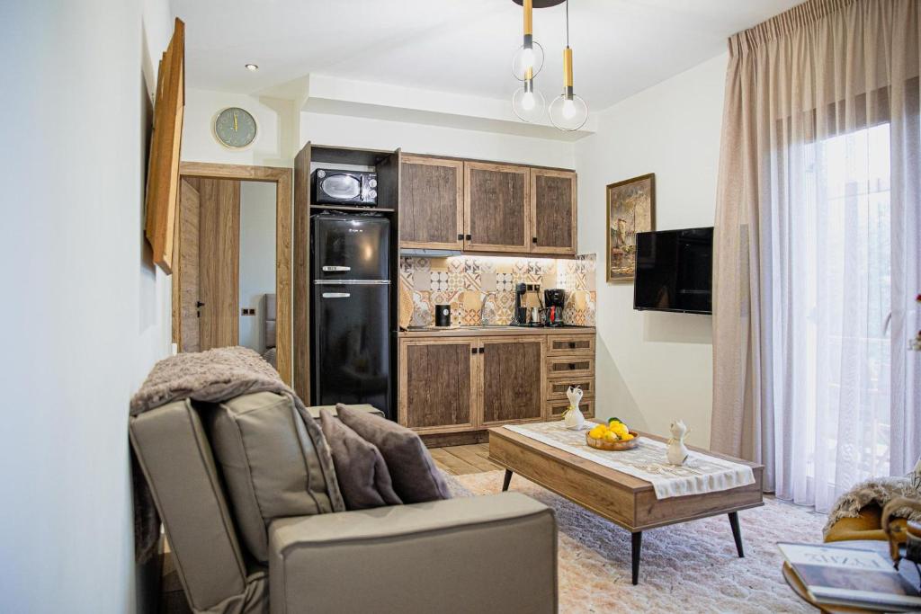 a living room with a couch and a table at Myrtilli Cottages Pelion in Áno Lekhónia