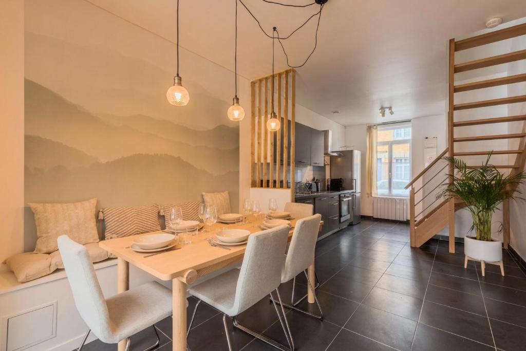 a kitchen and dining room with a table and chairs at 3 bedroom house with garden, near tram in Mouvaux