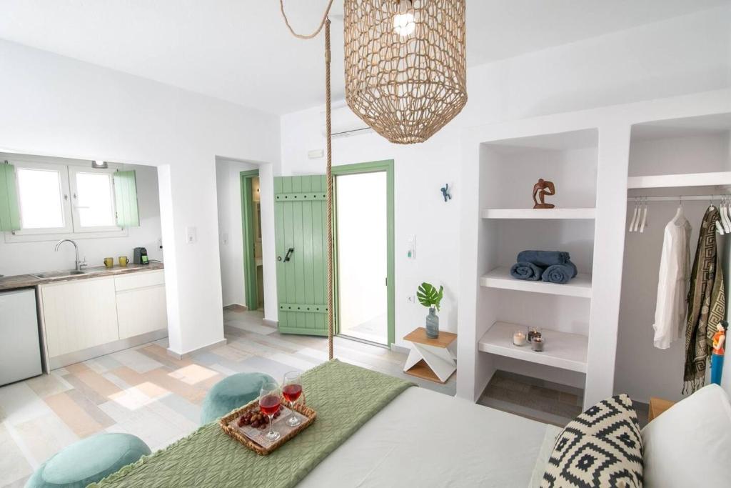 a kitchen and living room with a green door at Elite Houses Santorini in Emporio