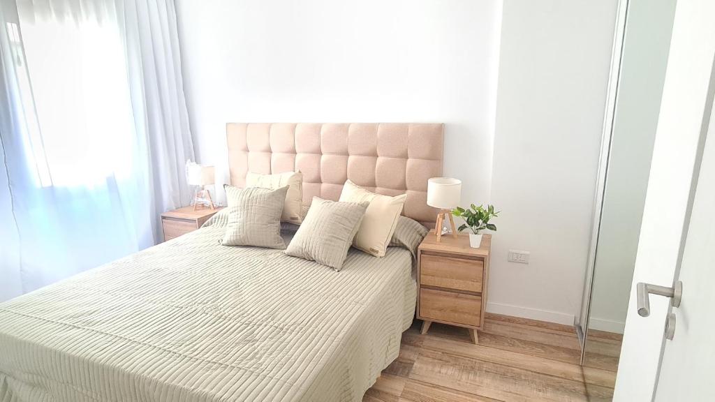 a bedroom with a large bed with white sheets and pillows at Sundara Tan perfecto que no vas a querer irte in Villa Carlos Paz