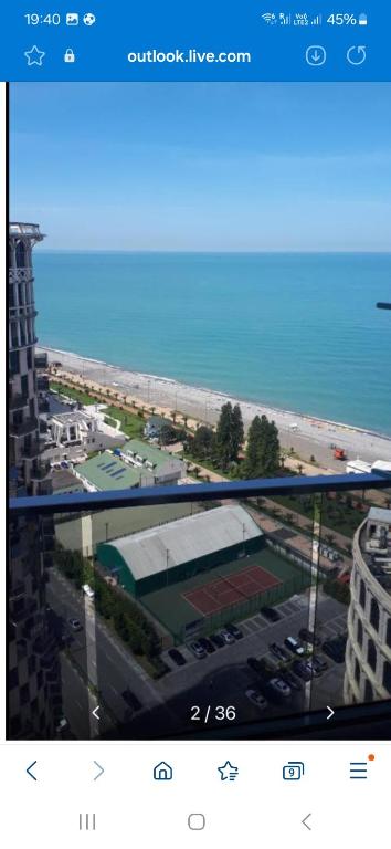 a screenshot of a screen with a view of a beach at ORBI 4 Seasons ApartHotel in Batumi