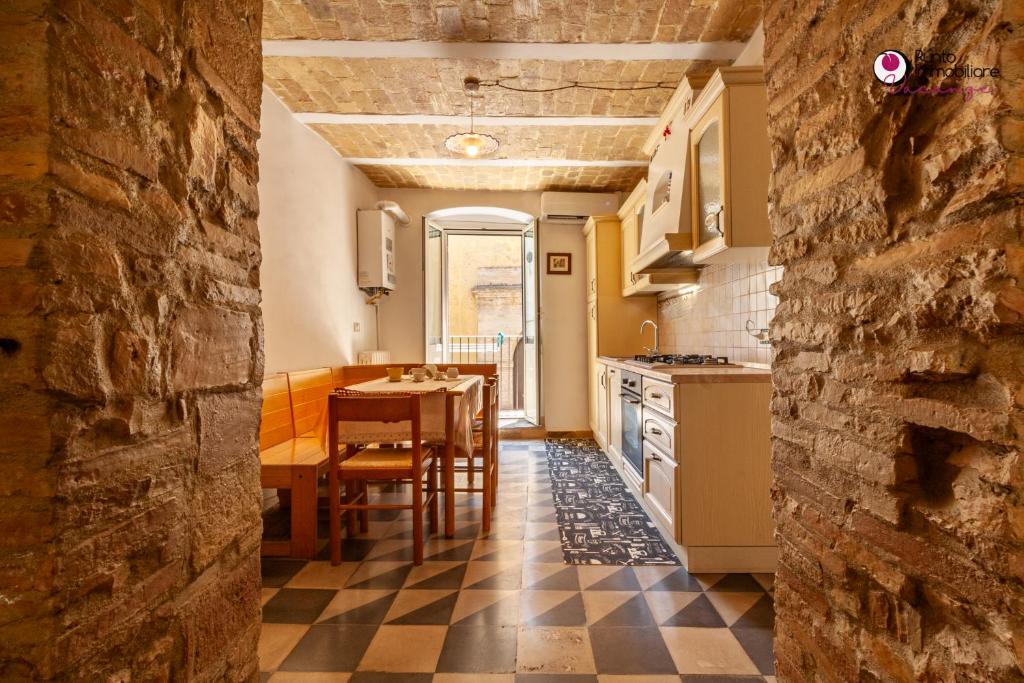 a kitchen with a table and a dining room at Casa Nel Borgo - WelcHome in Lanciano