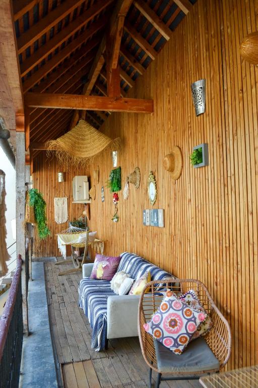 a living room with a couch in a wooden wall at A Nouste chambres d'hotes et gite ONLY ADULTS in Campan