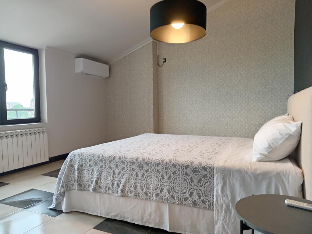 a bedroom with a white bed and a table at Medea's Home in Kutaisi