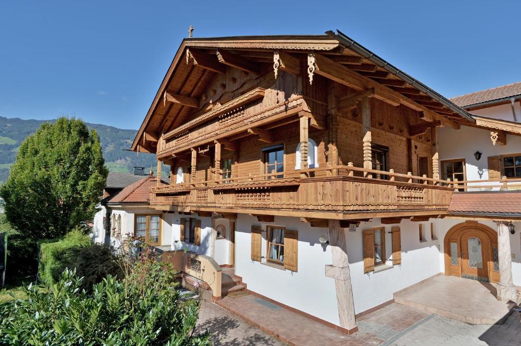 a large wooden house with a balcony on it at Haus Sonnenschein in Hart im Zillertal