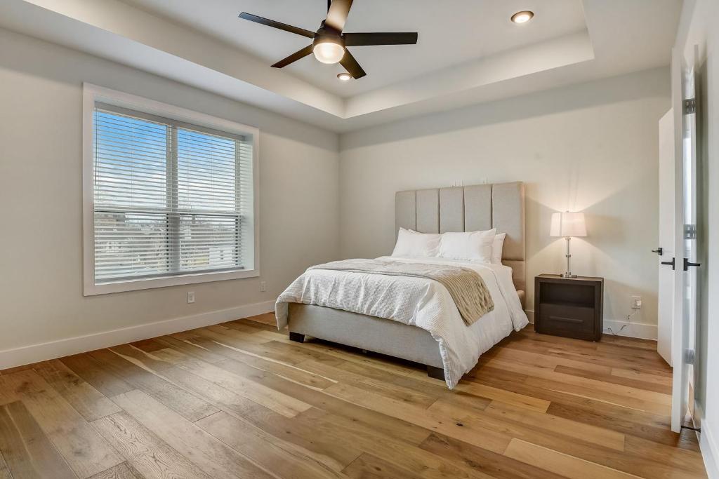 a bedroom with a bed and a ceiling fan at Munice at Trinity Grove in Dallas