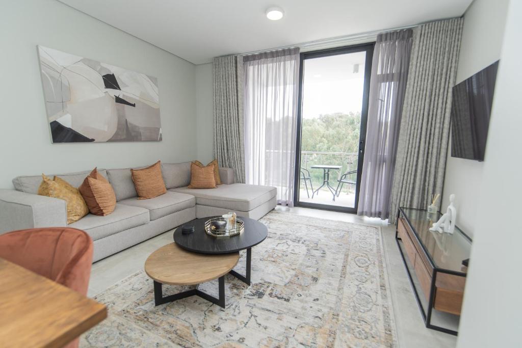 a living room with a couch and a table at Summerstrand Escape Bella Mare in Gqeberha