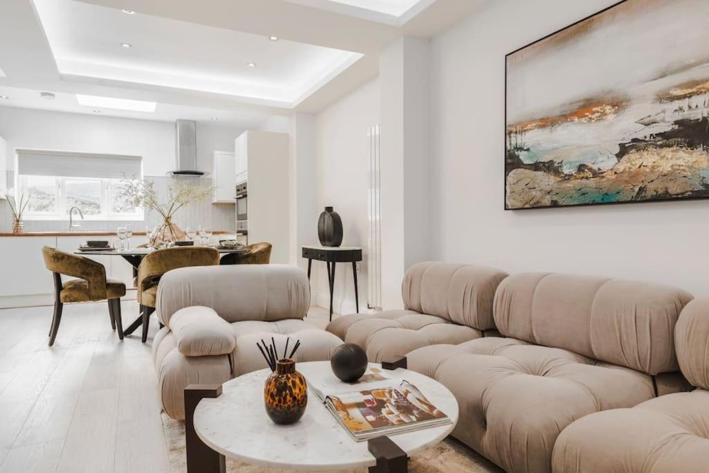 a living room with a couch and a table at Newly refurbished cosy 2 bed in Wembley in London