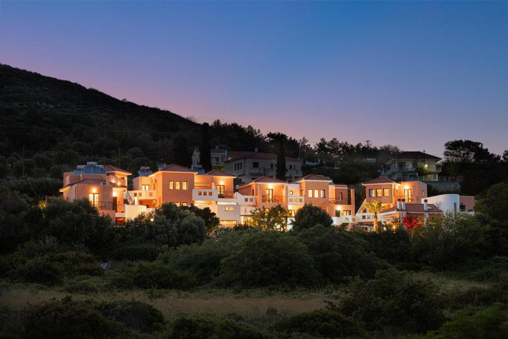 a group of houses on a hill at night at Nisea Hotel Samos in Pythagoreio