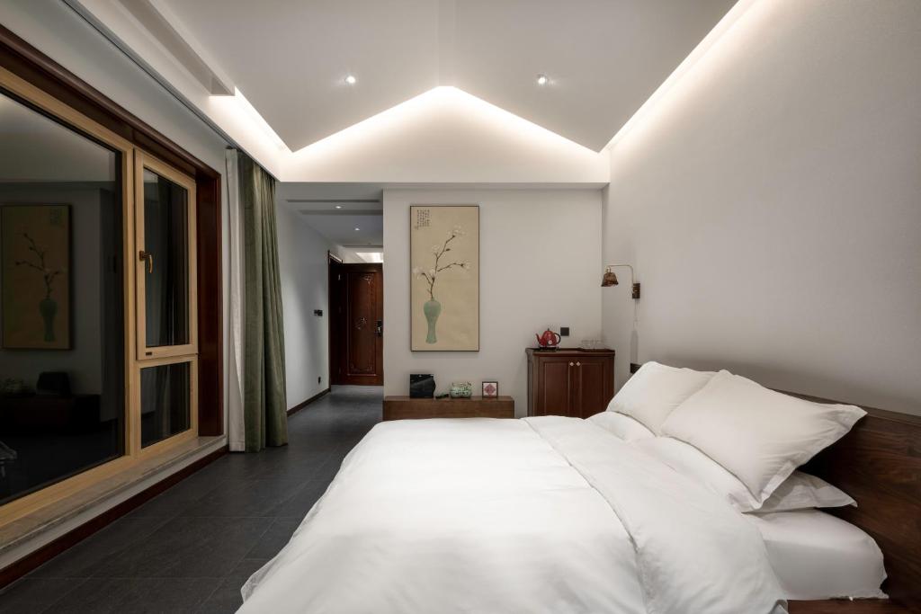 Postel nebo postele na pokoji v ubytování 五福居 Five Blessings Hotel