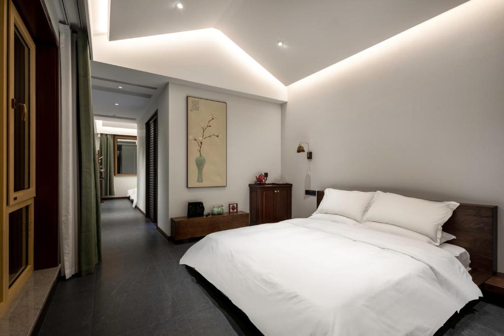 Postel nebo postele na pokoji v ubytování 五福居 Five Blessings Hotel