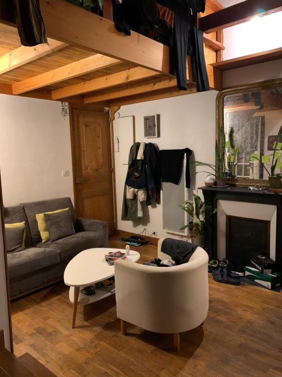 un salon avec un canapé et une table dans l'établissement Magnifique appartement métro Voltaire, à Paris