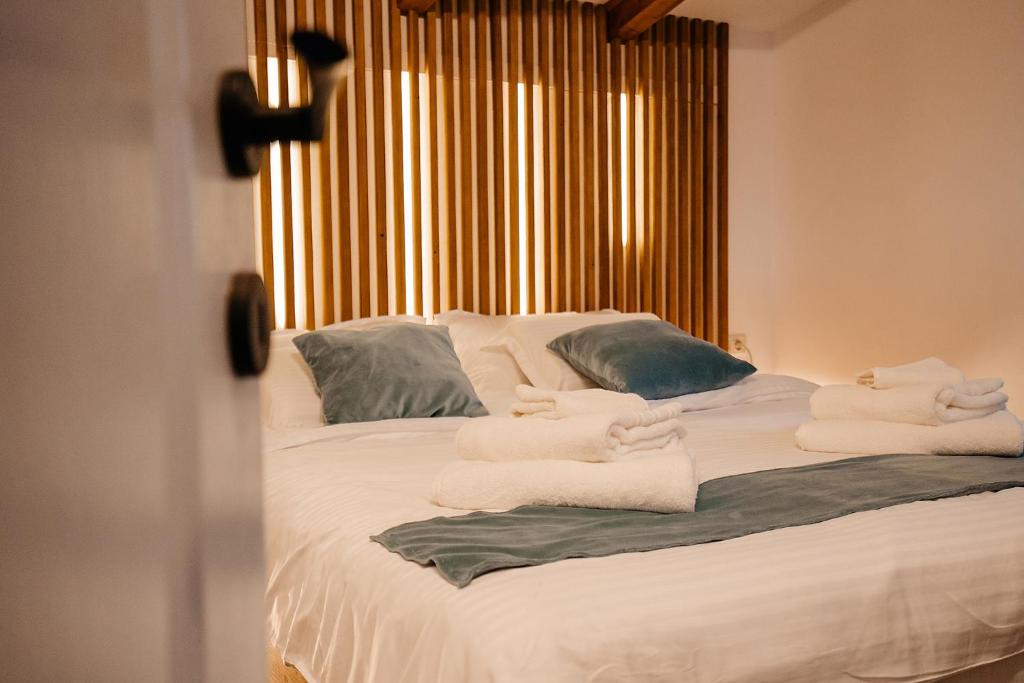a bedroom with a bed with towels on it at Cabana Allegro in Moisei