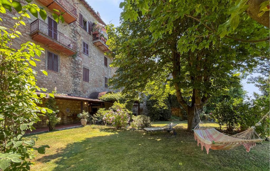 a hammock in a yard next to a building at Pet Friendly Home In Cetona in Cetona