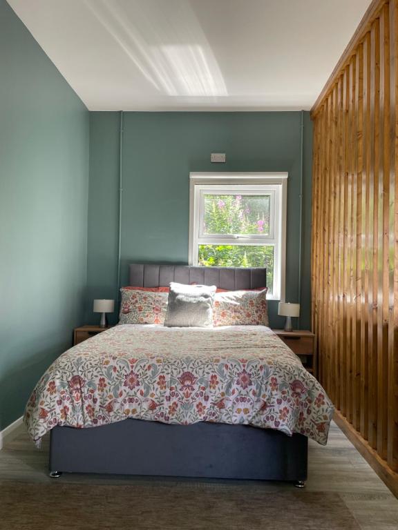 a bedroom with a large bed and a window at Studio in Letterkenny