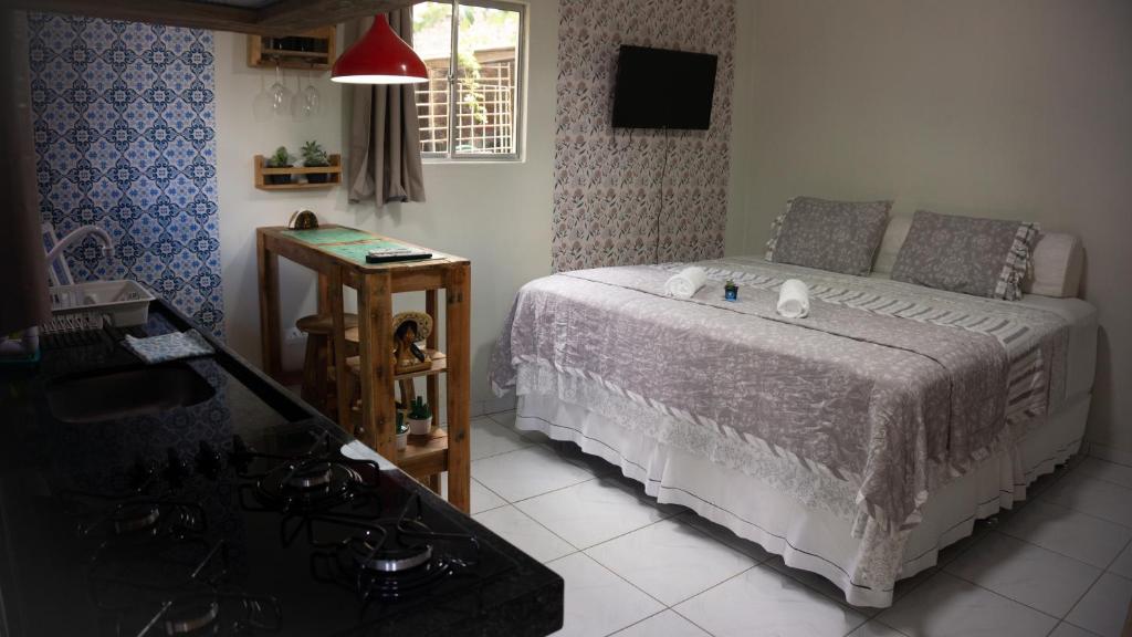 a small bedroom with a bed and a table at Pousada Viana in Garanhuns