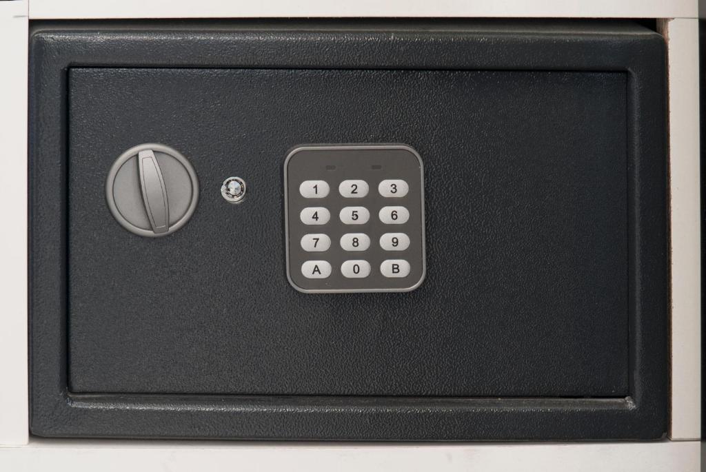 a black remote control on top of a microwave at JC Rooms Santo Domingo in Madrid