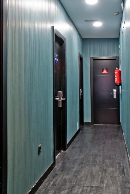 a hallway with two doors and a fire hydrant at JC Rooms Santo Domingo in Madrid