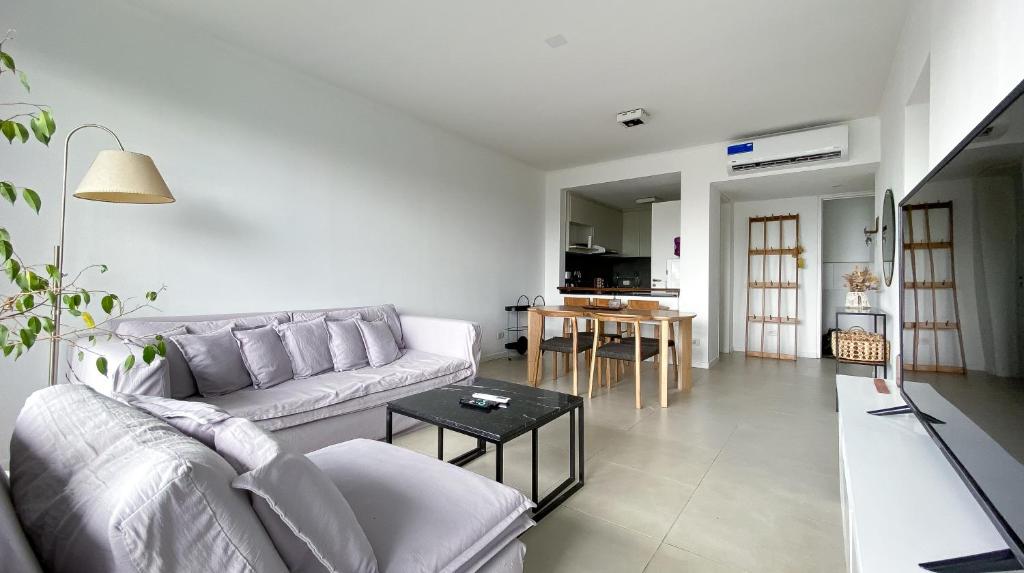 a living room with a couch and a table at VOHE Pilar I 3 Ambientes in Villa Rosa