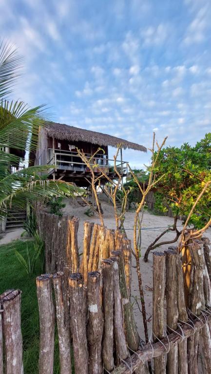 a group of logs in front of a house at Vila Barrinha in Acaraú