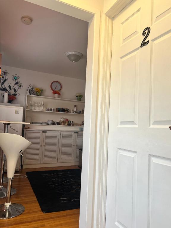 a door leading into a kitchen with a table at Cozy House B&B in Niagara Falls