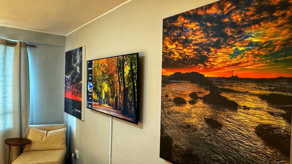 a room with two paintings on the wall at HOPE-always in Cape Town