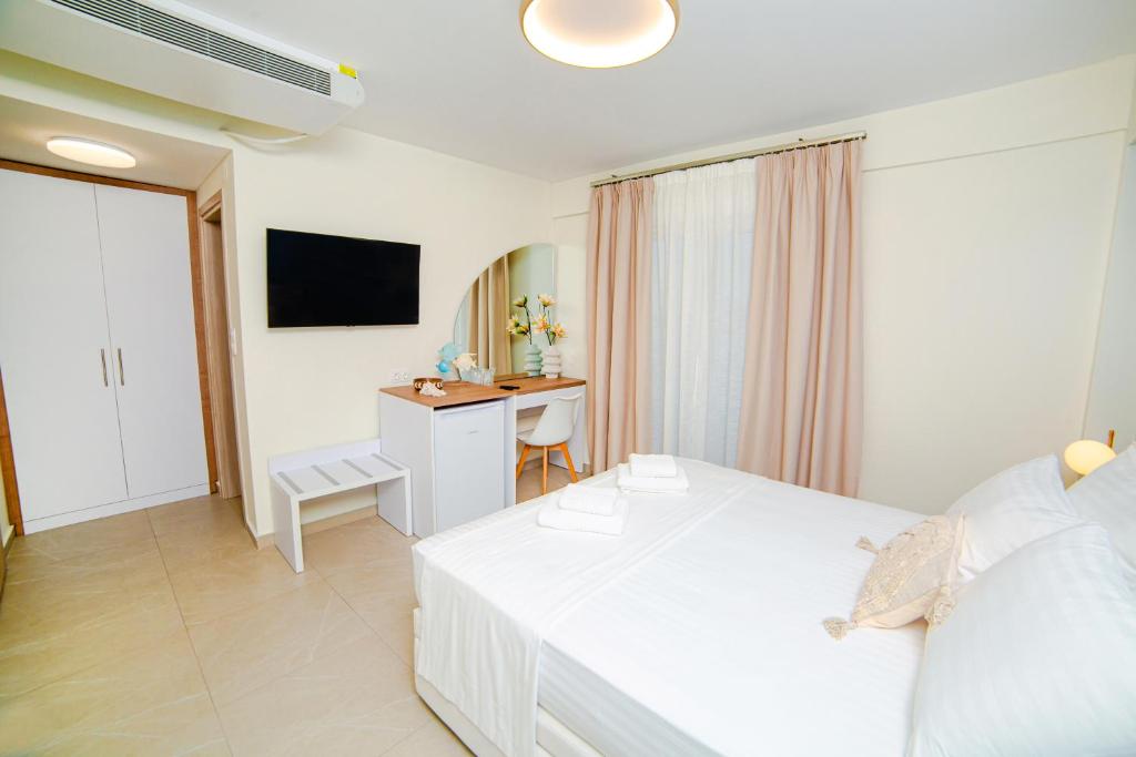 Televízia a/alebo spoločenská miestnosť v ubytovaní Hotel Ilion