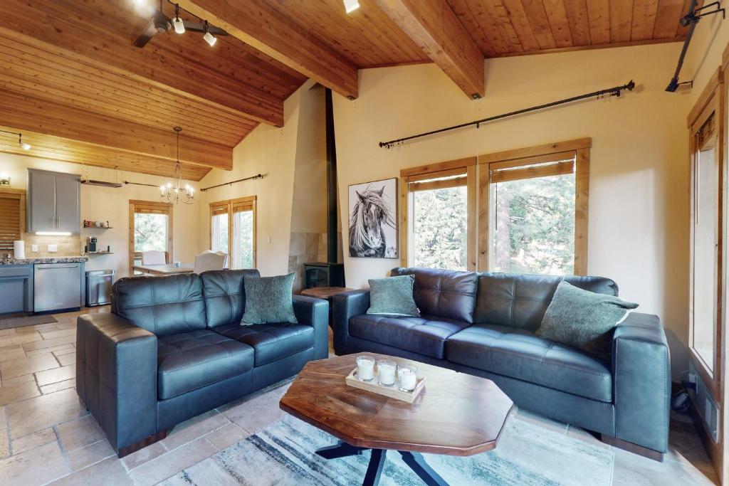 a living room with leather couches and a table at Wild Horse Hideaway in Incline Village
