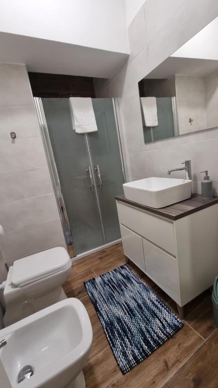 a bathroom with a toilet and a sink and a shower at Fly Napoli in Naples