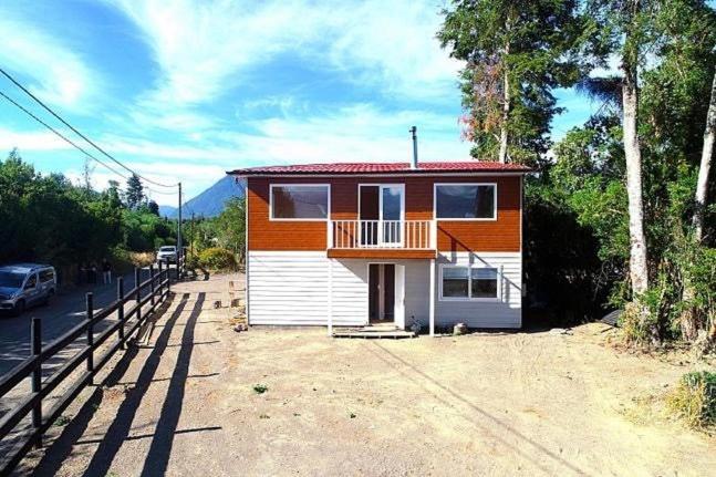 a small house with an orange and white at Cabañas ROMA, entre volcanes in Puerto Varas