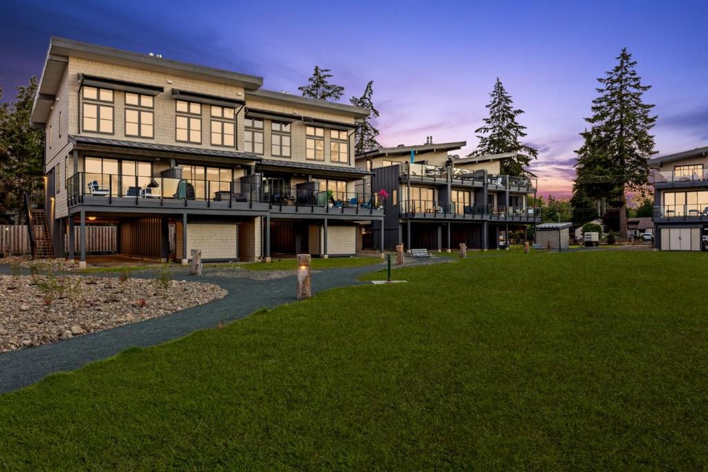 a large building with a lawn in front of it at Ocean View Townhouse #27 in Oyster Bay