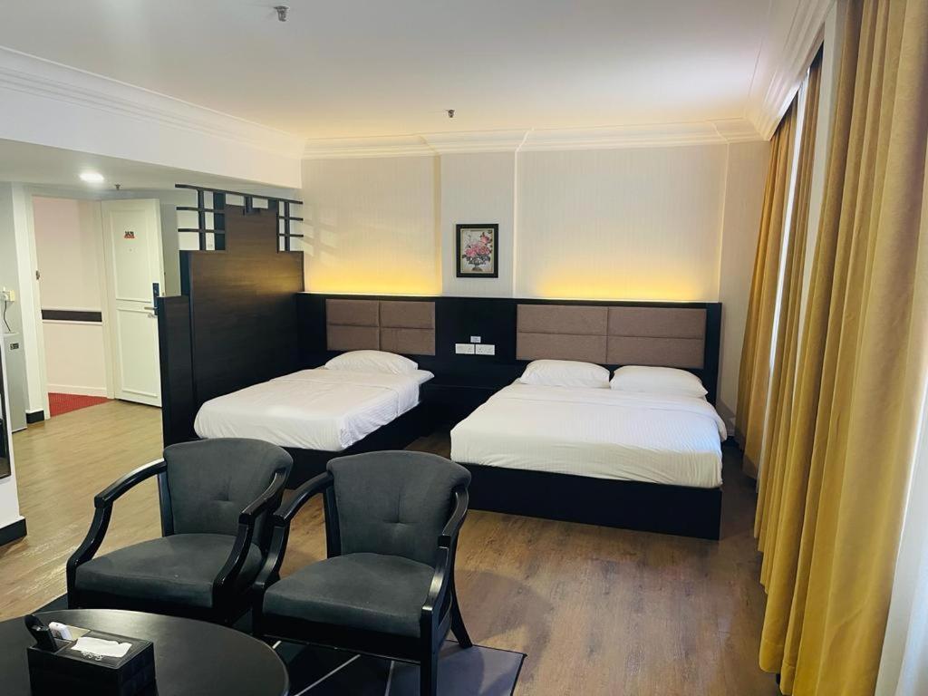 Postel nebo postele na pokoji v ubytování Remington Hotel