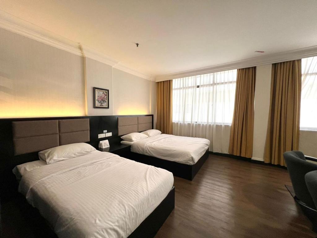 Postel nebo postele na pokoji v ubytování Remington Hotel