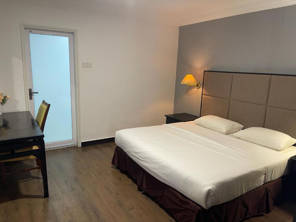 Postel nebo postele na pokoji v ubytování Remington Hotel