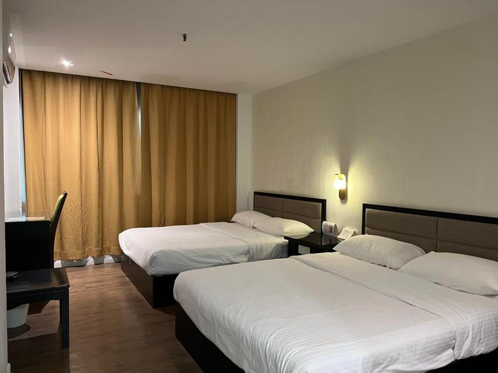 Postel nebo postele na pokoji v ubytování Remington Hotel