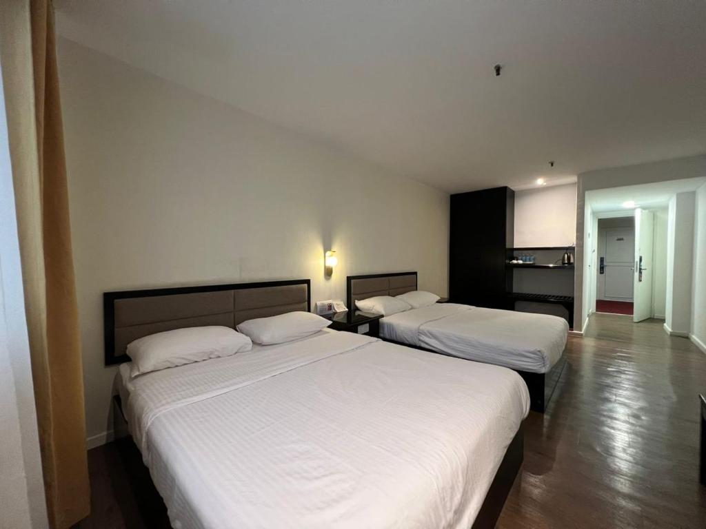 Postel nebo postele na pokoji v ubytování Remington Hotel