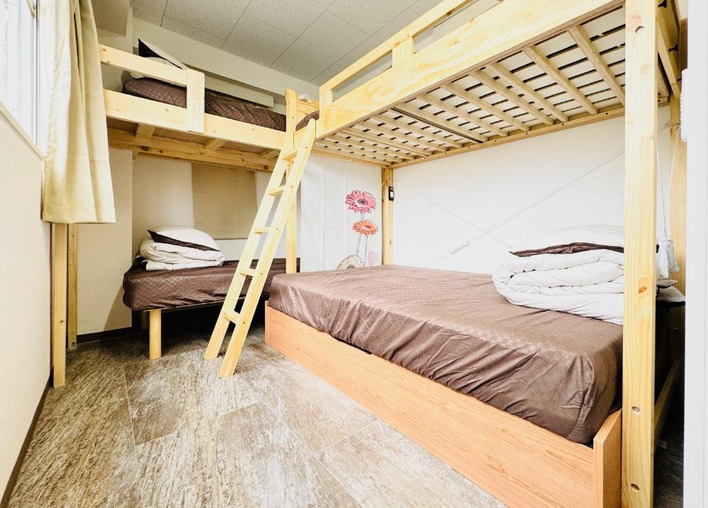 Postel nebo postele na pokoji v ubytování GUEST HOUSE B's FiveⅡ