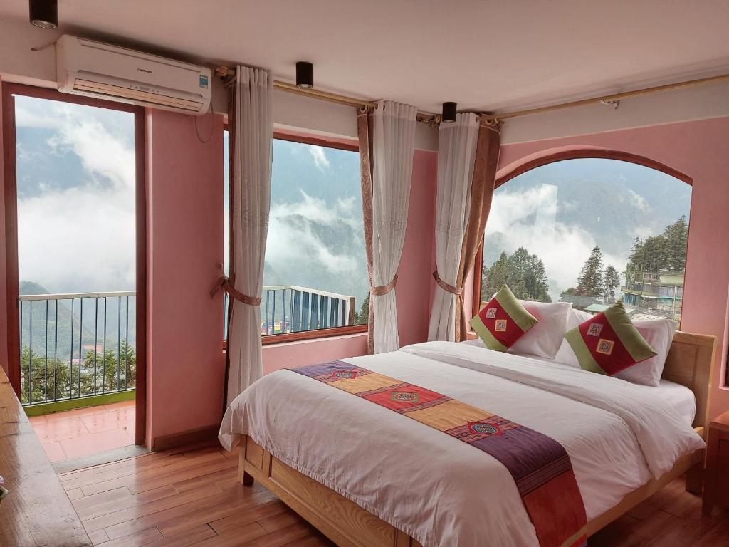 a bedroom with a bed with a large window at Sapa Scenery Hotel in Sa Pa