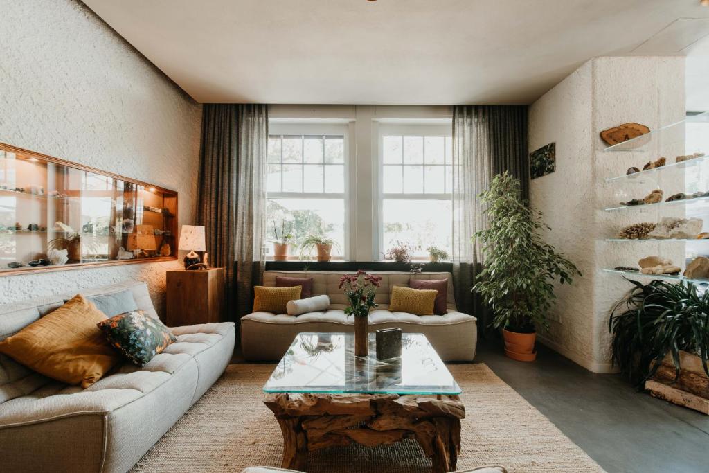 a living room with a couch and a table at Hotel Restaurant Le Cigalon in Waldbillig
