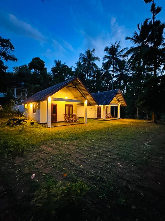 a small house at night with lights at Walawe Palm Villa in Udawalawe