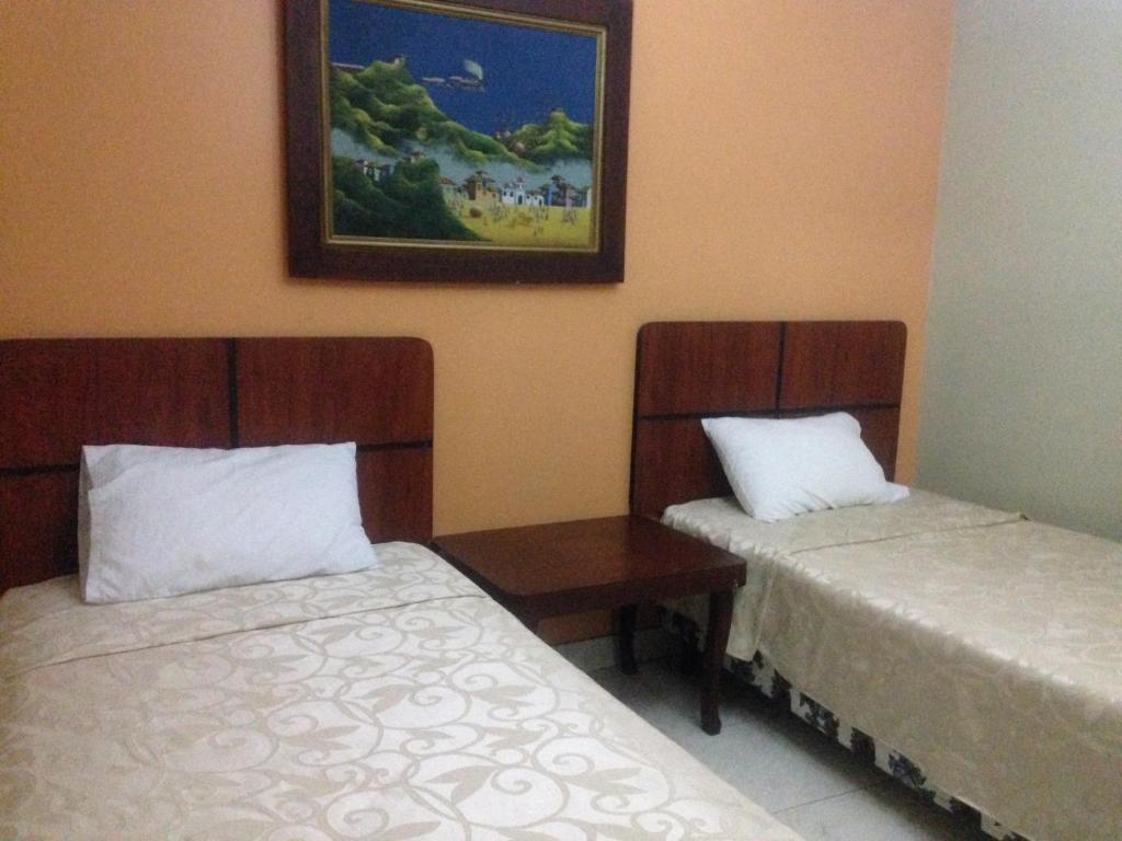 Postel nebo postele na pokoji v ubytování Tropical Inn Hotel