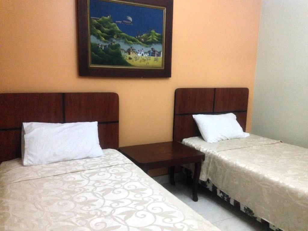 Postel nebo postele na pokoji v ubytování Tropical Inn Hotel